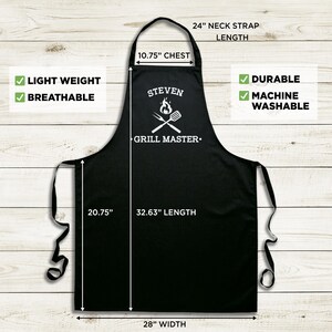 May include: Black grill master apron with white text and a grill graphic. The apron measures 32.63 inches long, 28 inches wide, and has a 10.75 inch chest measurement. The neck strap is 24 inches long. The apron is lightweight, breathable, durable, and machine washable.