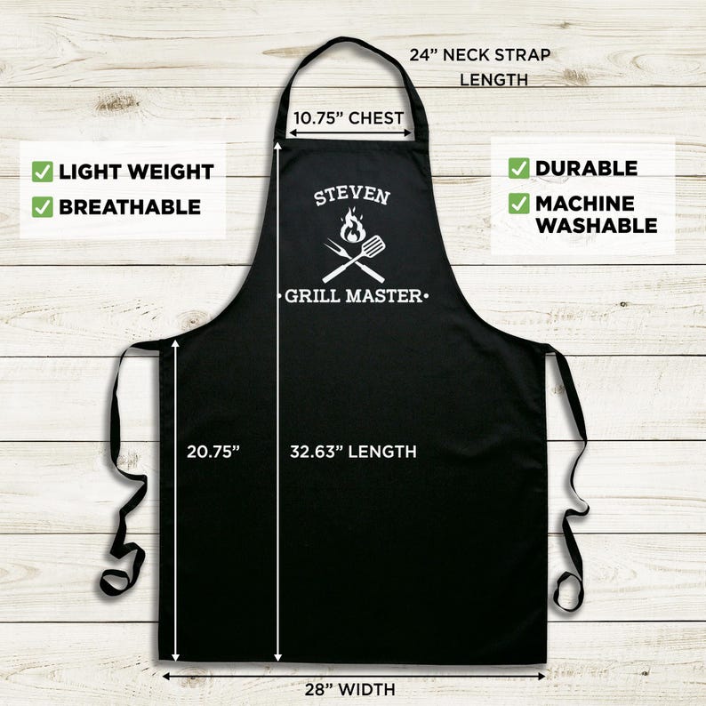 May include: Black grill master apron with white text and a grill graphic. The apron measures 32.63 inches long, 28 inches wide, and has a 10.75 inch chest measurement. The neck strap is 24 inches long. The apron is lightweight, breathable, durable, and machine washable.