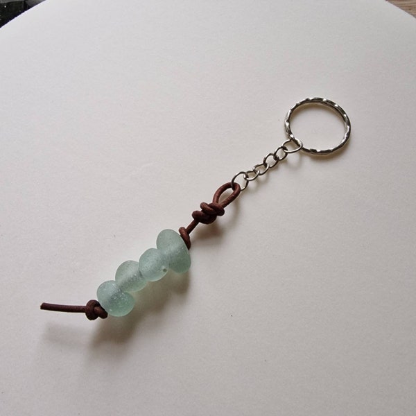 Genuine Seaham sea glass leather key ring/key chain/zip pull. In pale aqua blue glass. Naturally surf tumbled.