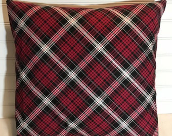 May include: Red, black, and white plaid throw pillow. The pillow is square and has a diamond pattern.