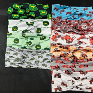May include: A set of ten colorful headbands with a tractor print. The headbands are made of a soft, stretchy fabric and feature a variety of tractor designs, including John Deere and Case.