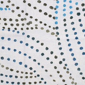 May include: White fabric with a repeating pattern of blue and brown dots.