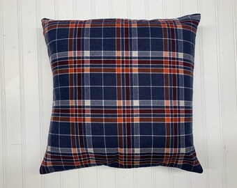 May include: A blue, red, and white plaid throw pillow. The pillow is made of a soft, textured fabric.