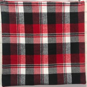 May include: Red, black, and white plaid fabric with a subtle gray pattern. The fabric has a soft, fuzzy texture.