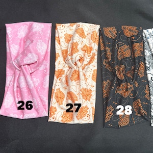 May include: Five different patterned headbands with the Harley Davidson logo. The headbands are in red, pink, white, black, and white with a paisley pattern. The headbands are numbered 25, 26, 27, 28, and 34.