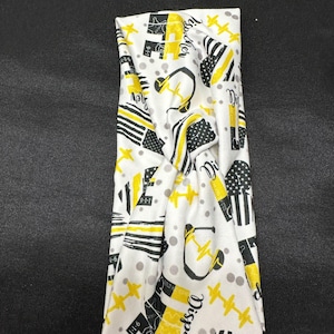 May include: White and yellow patterned headband with the word "Dispatcher" and other symbols, including a headset, a star, and a thin yellow line.