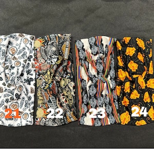 May include: Four different patterned headbands with a black, white, and orange color scheme. The headbands feature a Harley Davidson logo and other motorcycle-themed designs. The headbands are numbered 21, 22, 23, and 24.