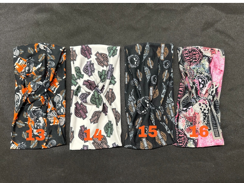 May include: Four different patterned headbands with a twist design. The headbands are black, white, black, and pink with various Harley Davidson logos and designs. The headbands are numbered 13, 14, 15, and 16.