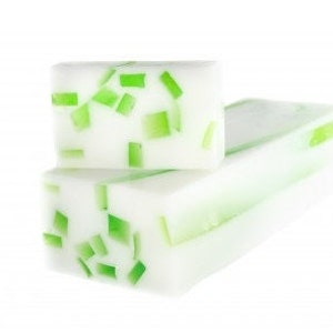 May include: Two bars of white soap with green flecks throughout. The soap is translucent and the green flecks are visible throughout the bars.
