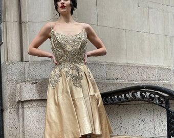50s dress. glamorous champagne color silk dress.  party dress with beads and sequins decorating front and back