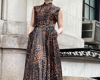 50's sleeveless black and orange cotton printed dress, long zipper in the back, pocket on either side of dress, slight V neckline