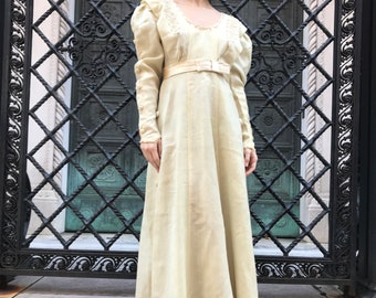 1900's cream wool long sleeve dress with 8 buttons down the middle of either sleeve , embroidery detail along the collar,