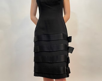 60s black dress, scoop neck, fit look, 4 layers of silk bows at the skirt