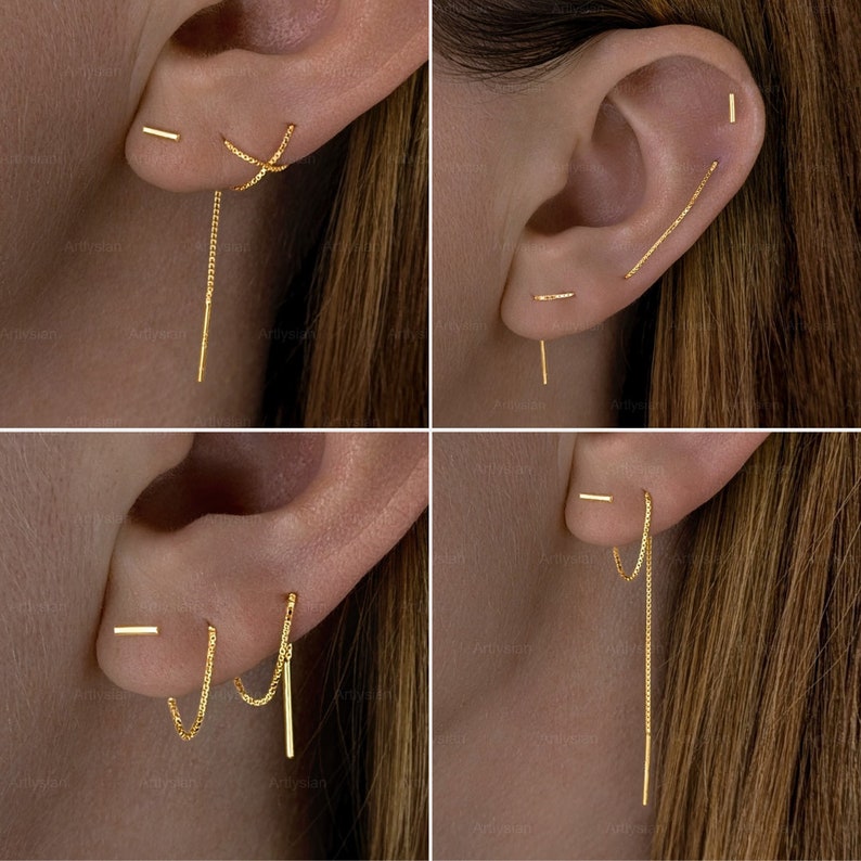Op de afbeelding: Een collectie gouden oorbellen, waaronder staafjes, kettingoorbellen en draadoorbellen. De oorbellen worden getoond op een oor, waarbij verschillende ontwerpen en stijlen worden getoond. De sieraden zijn eenvoudig en elegant.