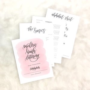 May include: A set of printable worksheets for learning modern brush lettering. The worksheets include a title page with the text "modern brush lettering", a page with the text "the basics", and a page with the text "alphabet sheet" with practice lines for different letters.