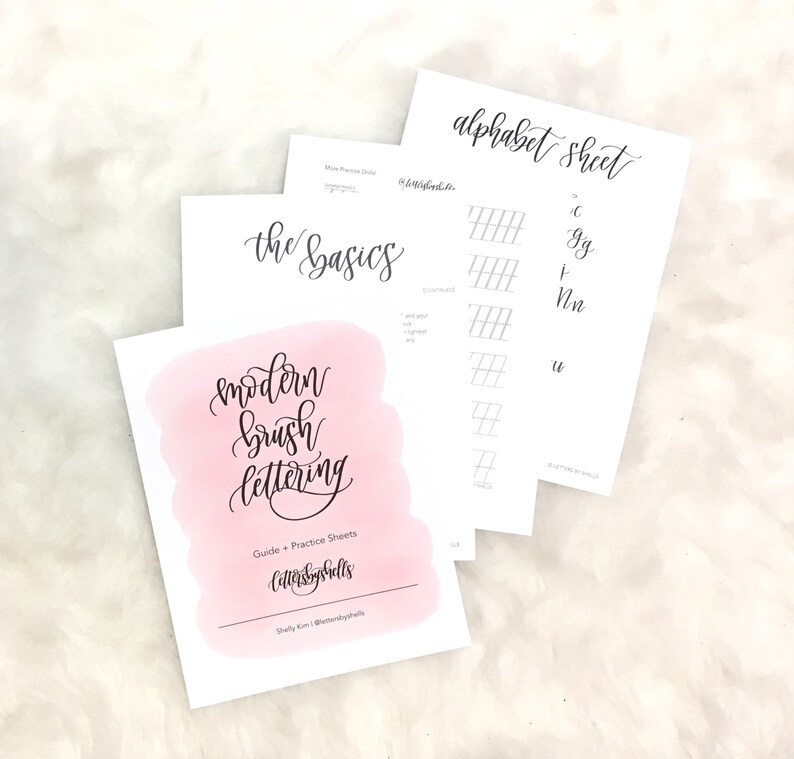 May include: A set of printable worksheets for learning modern brush lettering. The worksheets include a title page with the text "modern brush lettering", a page with the text "the basics", and a page with the text "alphabet sheet" with practice lines for different letters.