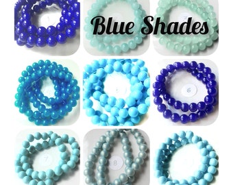 May include: Eight strands of round beads in various shades of blue, including light blue, turquoise, and dark blue. The beads are arranged in a grid pattern, with each strand labeled with a number from 1 to 8. The text "Blue Shades" is displayed above the beads.