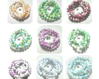 May include: A collection of nine circular strands of round, multi-colored speckled beads, each labeled with a number from 85 to 93. The beads feature various color combinations including orange, green, red, blue, purple, and white patterns.