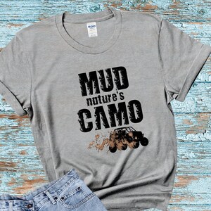 May include: A gray t-shirt with the text "Mud nature's camo" and a black silhouette of an off-road vehicle with mud splatters.