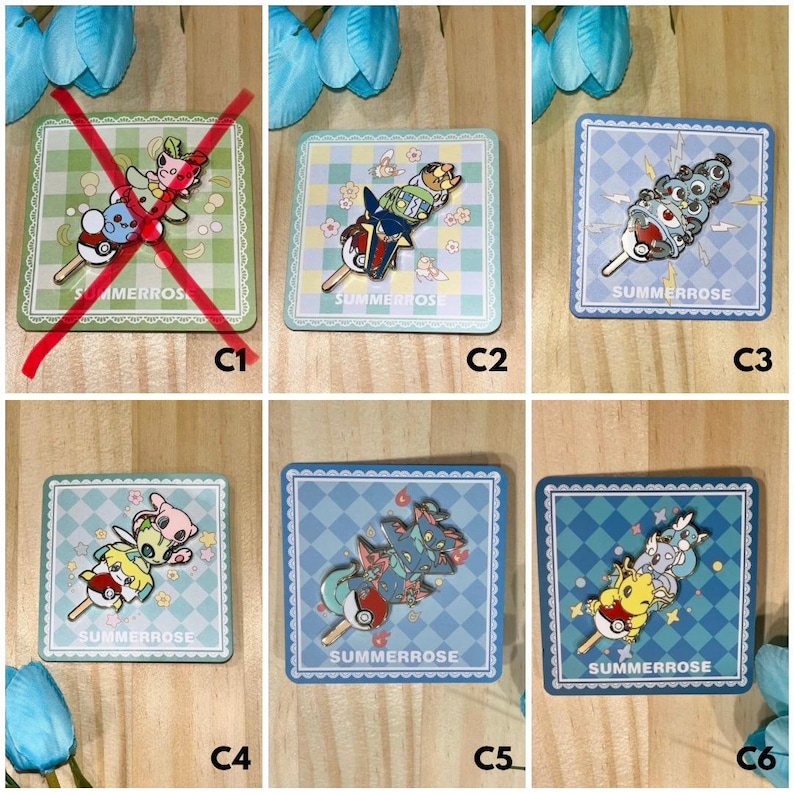 May include: A collection of five square enamel pins featuring stacked cartoon creatures on sticks, each displayed on a matching patterned backing card with the text SUMMERROSE. The designs include various colorful characters and pokeball motifs.