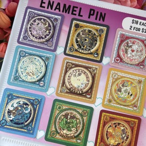 May include: A collection of enamel pins with intricate, stained-glass style designs. Each pin features a circular emblem with a different character, set within a square frame. The pins are in various colors, including blue, green, and gold, with the text "ENAMEL PIN" at the top.