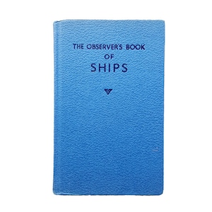 May include: A blue book with the title "The Observer's Book of Ships" printed in navy blue lettering.