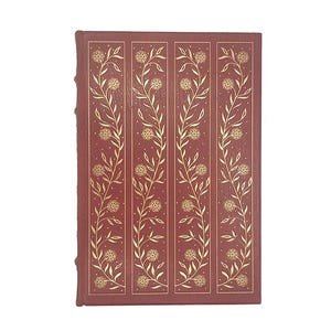 May include: A red hardback book with a gold floral design on the cover.