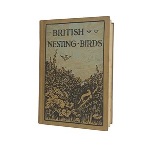 May include: A vintage book titled "British Nesting Birds" with a tan cover and illustrations. The cover displays the title in a serif font, a bird in flight, and a detailed nature scene with a bird's nest.