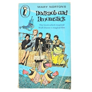 Może przedstawiać: Vintage okładka książki w miękkiej oprawie do "Bedknob and Broomstick" Mary Norton. Okładka zawiera ilustracje postaci z opowieści, w tym kobietę, dzieci i animowane ryby. Tytuł i autor książki są wyświetlane u góry.