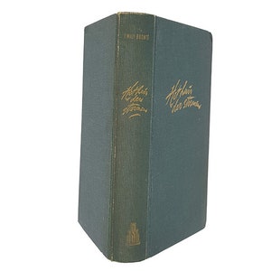 May include: A green hardcover book with the title "Wuthering Heights" by Emily Brontë written in gold lettering on the spine.