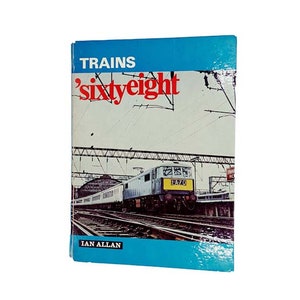 以下が含まれることがあります： 「Trains 'sixty eight'」というタイトルの青と白の表紙の本で、表紙には電車の写真が載っています。電車は青と白の電気機関車で、客車を牽引しています。機関車には「DA70」という番号が書かれています。この本は、イアン・アランによって出版されています。