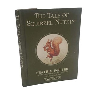 May include: A green book cover with the title "The Tale of Squirrel Nutkin" in white text. The cover features an illustration of a red squirrel holding a nut, against a white background.