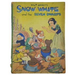 May include: A vintage book cover featuring a colourful illustration of Snow White and the Seven Dwarfs. The cover is yellow with the title "Walt Disney's Snow White and the Seven Dwarfs" in black text. The illustration shows Snow White standing with her arms outstretched, while the dwarfs are playing music and singing.