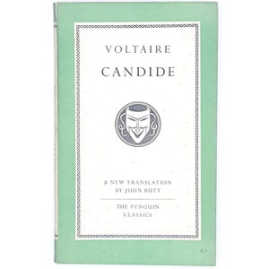 May include: A green book cover with the title "VOLTAIRE CANDIDE" in white text. The cover also features a black and white illustration of a theatrical mask and the text "A NEW TRANSLATION BY JOHN BUTT" and "THE PENGUIN CLASSICS".