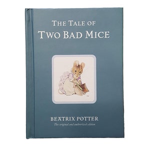 May include: A blue hardcover book titled "The Tale of Two Bad Mice" by Beatrix Potter. The original and authorized edition is printed on the cover. The cover features an illustration of a mouse in a pink dress holding a paintbrush.