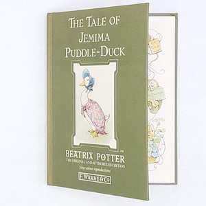 May include: A green hardback book featuring an illustration of a duck wearing a blue bonnet and a pink dress. The title of the book is "The Tale of Jemima Puddle-Duck" by Beatrix Potter. This is part of the original and authorised edition with new colour reproductions.