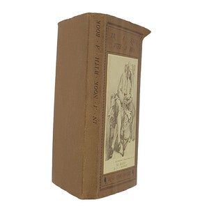 May include: A brown book with the title "In a Nook with a Book" on the spine. The cover features a black and white illustration of a person sitting in a chair with a book.