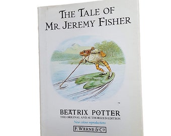 May include: The Tale of Mr. Jeremy Fisher book cover featuring an illustration of a frog in a waistcoat and hat, rowing a boat made of a lily pad. The book is by Beatrix Potter, the original and authorized edition with new color reproductions published by F. Warne & Co.