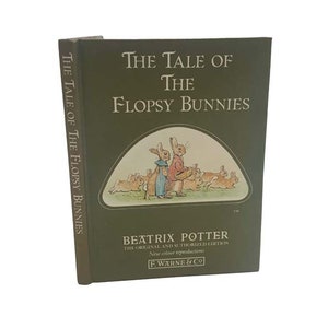 May include: A green hardcover book titled "The Tale of the Flopsy Bunnies" by Beatrix Potter. The book features an illustration of bunnies on the front cover.