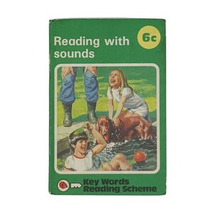 May include: Green book cover with a keyhole graphic and the text "The Key to reading SUCCESS The Ladybird Key Words Reading Scheme". The text describes a reading program for children.