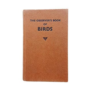 以下が含まれることがあります： 黒い文字で「The Observer's Book of Birds」というタイトルが印刷された、茶色の革装丁の本です。