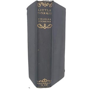 May include: A vintage hardback book titled "Little Dorrit" by Charles Dickens, published by Macmillan & Co.