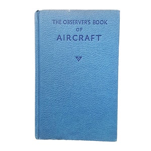 May include: A blue book with the title "The Observer's Book of Aircraft" printed in white on the front cover.
