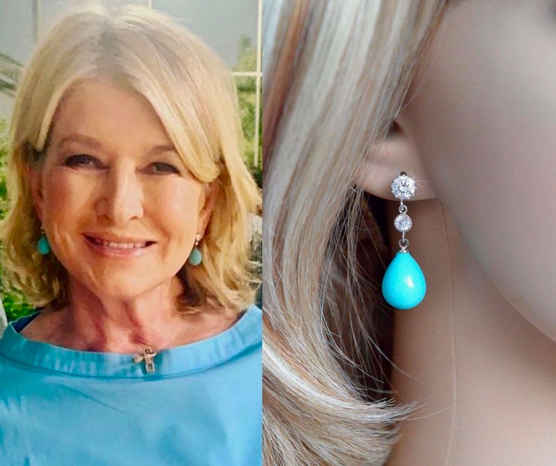 May include: Turquoise teardrop earrings with a silver setting and clear cubic zirconia stones. The earrings are dangling from the earlobe.