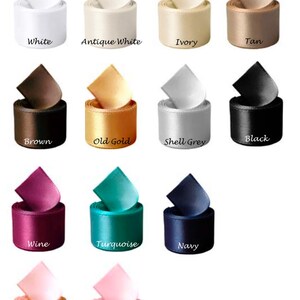 May include: A collection of 14 spools of satin ribbon in various colours, including white, antique white, ivory, tan, brown, old gold, shell grey, black, wine, turquoise, navy, blush, and powder pink.