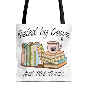 May include: White tote bag with black handles. The design features the text "Fueled by Coffee And Plot Twists", a stack of books, a coffee cup with "Book Nerd" on it, and a stack of books.