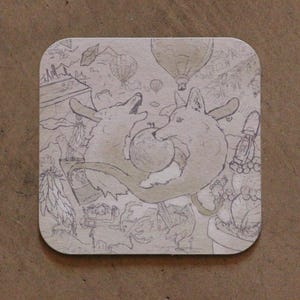 May include: A square coaster with rounded corners featuring a light brown surface and a dark brown line drawing. The illustration depicts two foxes facing each other, a central sphere, hot air balloons, cacti, a lantern, and a bird.