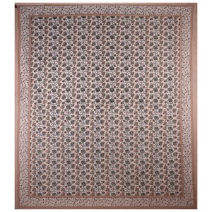 May include: A white cotton fabric with a repeating pattern of small brown and green floral designs. The fabric has a border of a light brown floral pattern.