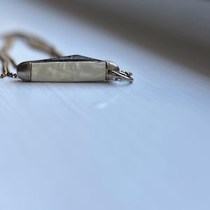 Vintage Mother Of Pearl miniature working pocket knife pendant necklace with original advertisement still in awesome condition