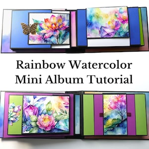 May include: A rainbow watercolor mini album tutorial featuring a colorful floral design with crystals and a butterfly. The album is made of cardstock and has a black border.